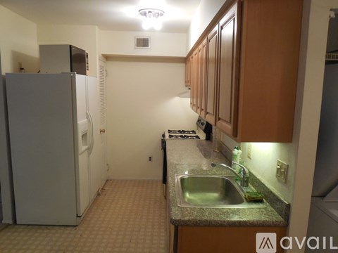 A kitchen with a sink and a refrigerator.