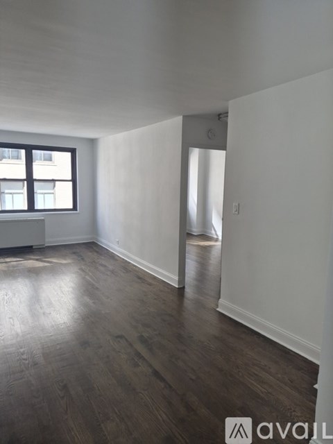 A room with wooden floors and white walls.