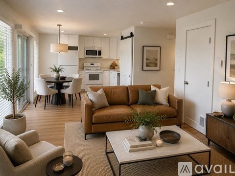 A living room with a brown couch and a coffee table.