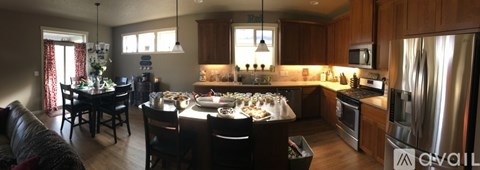 A kitchen with a dining table and chairs.