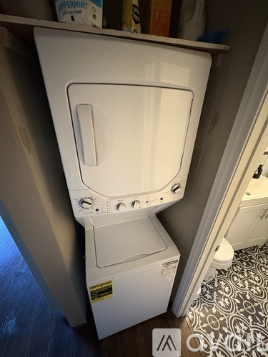 A white toilet is installed in a small space.