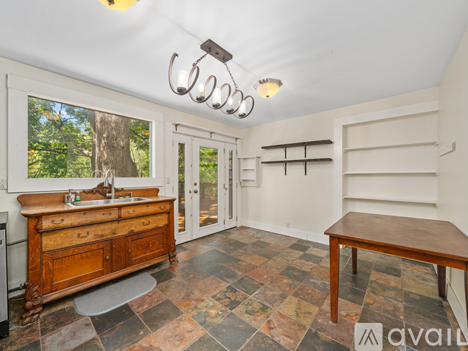 A kitchen with a wooden counter and a window.