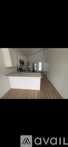A room with a white cabinet and a microwave on top of it.