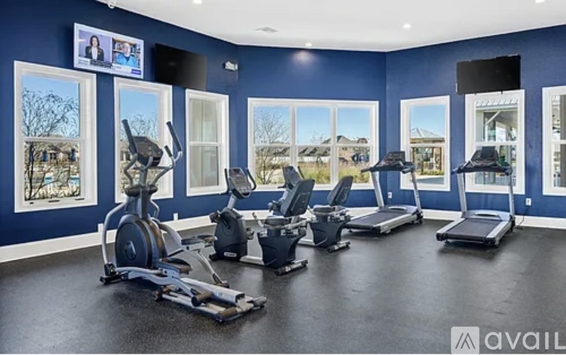 A gym with treadmills and exercise bikes.