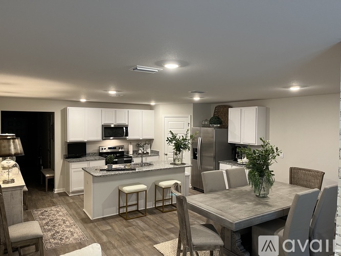 A modern kitchen with a dining table and chairs.