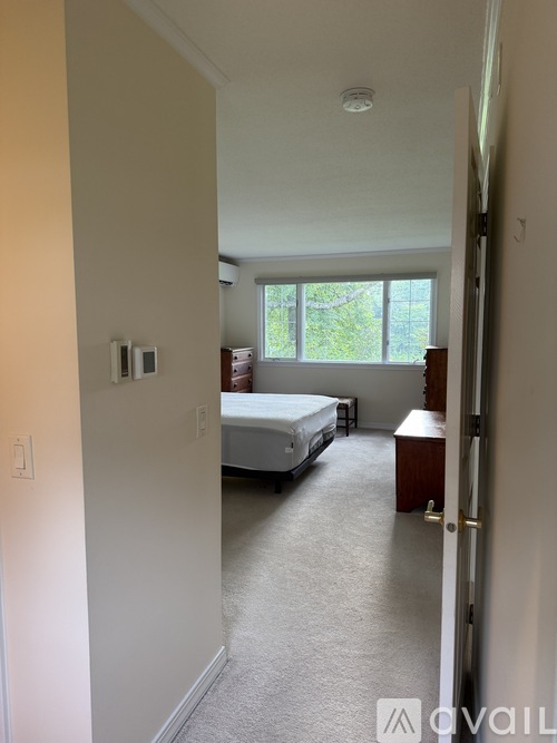 A bedroom with a bed and a window.