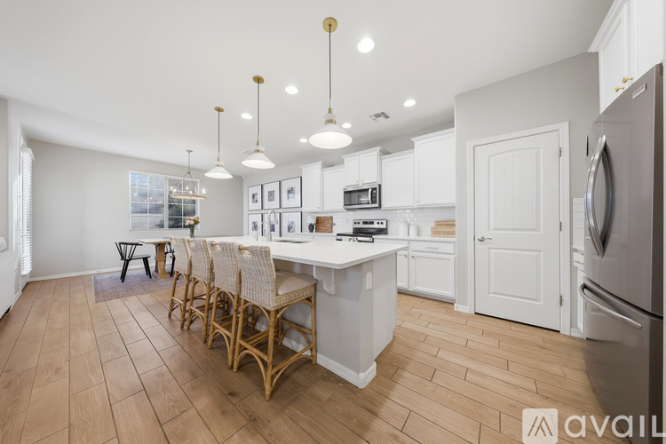 A kitchen with a table and chairs in the middle of the room.