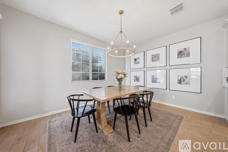 A dining room with a table set for four.