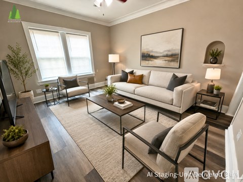A living room with a white couch, a glass coffee table, and a painting on the wall.