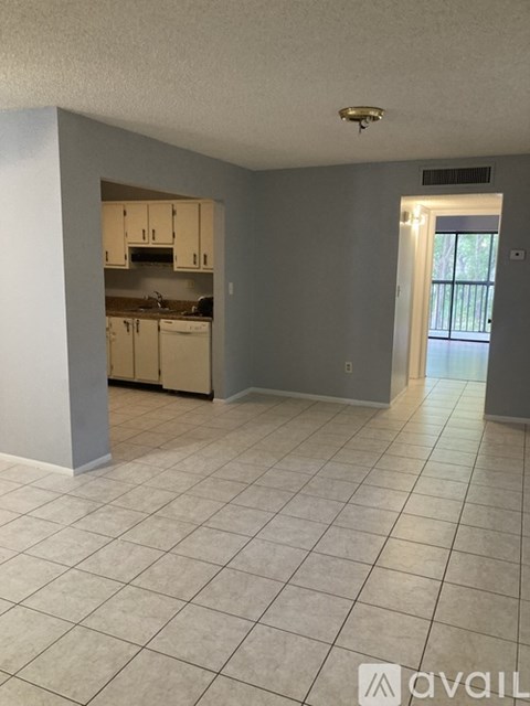 A kitchen with white cabinets and a white dishwasher.