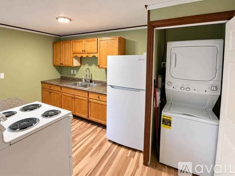 A kitchen with a white stove and a white refrigerator.