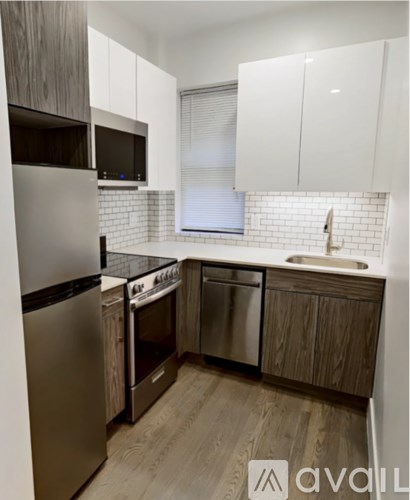 A kitchen with wooden cabinets and stainless steel appliances.