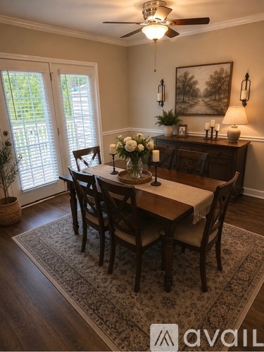 A dining room with a table set for four.