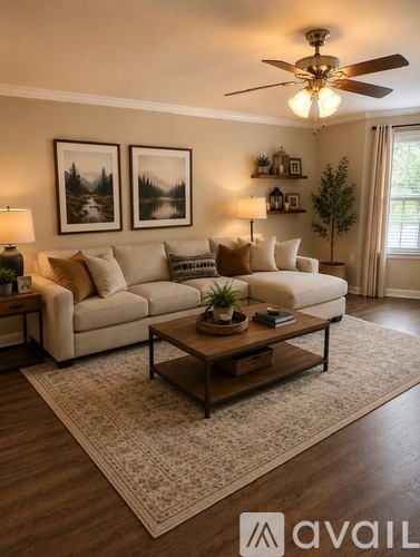 A living room with a white couch, a coffee table, and a ceiling fan.