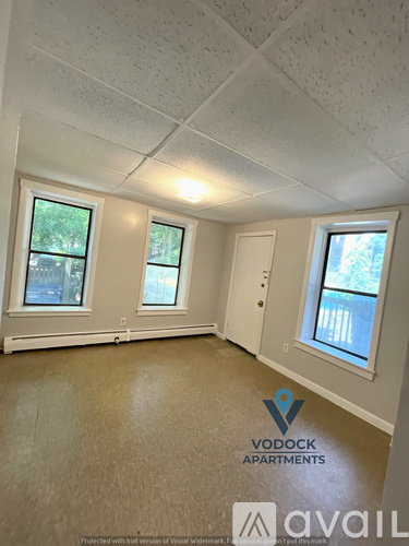 A room with Vodock Apartments logo on the floor.