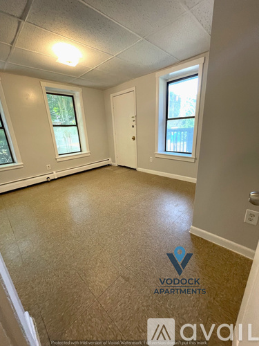A room with Vodock Apartments logo on the floor.