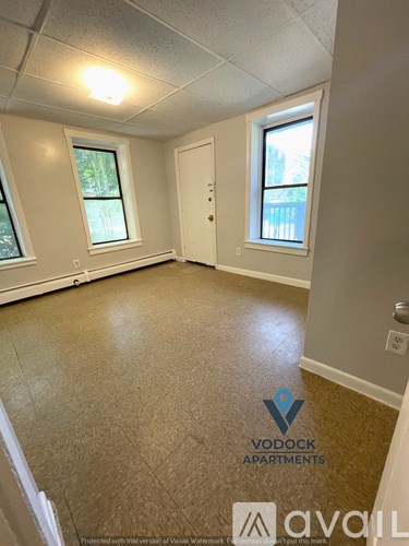 A room with Vodock Apartments logo on the floor.