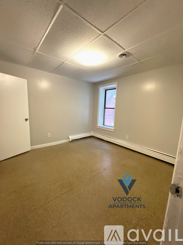 A room with a Vodock Apartments logo on the floor.