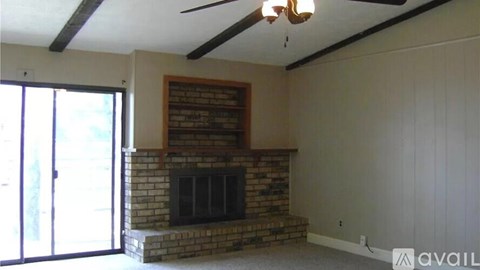 A living room with a fireplace and sliding glass doors.