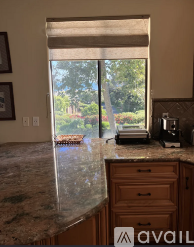 A kitchen counter with a marble top and wooden drawers.