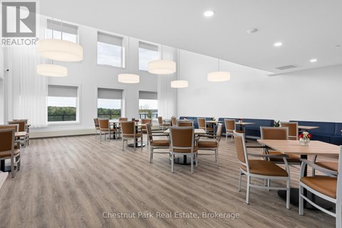A modern dining room with wooden floors and furniture.