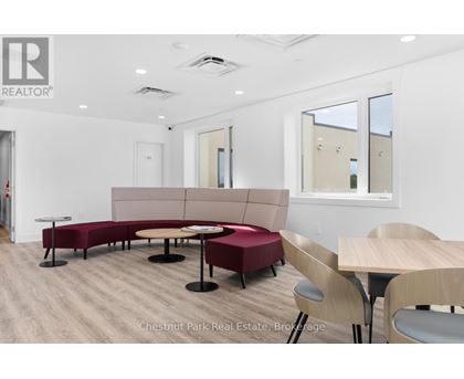 A conference room with a long table and chairs.
