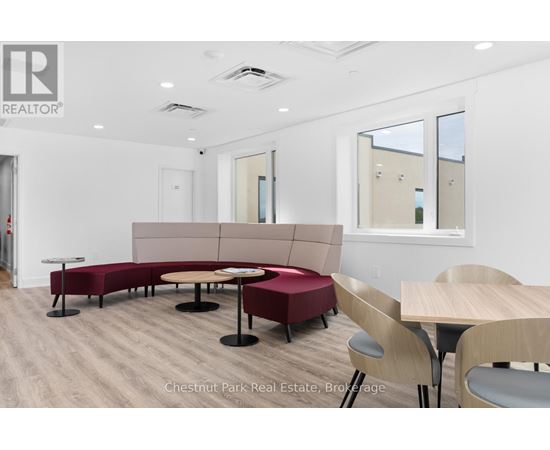 A conference room with a long table and chairs.