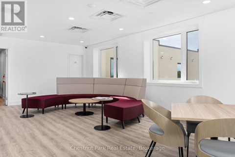 A conference room with a long table and chairs.