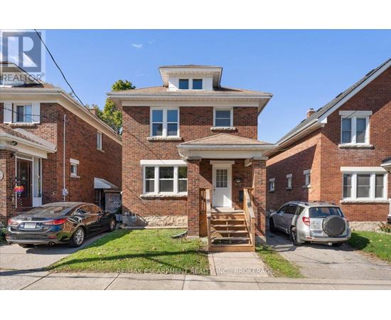 A house with a car parked in front of it.