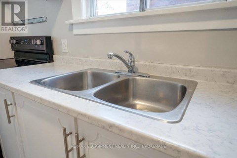 A kitchen with a sink and a window.