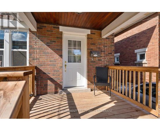A white door is on the brick house.