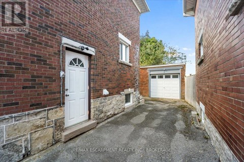 A brick building with a white door and windows.