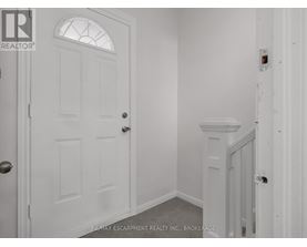 A white door with a glass window is in a room with white walls.