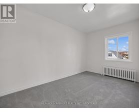 A room with a window and a radiator on the floor.