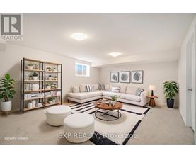 A living room with a white couch, a coffee table, and a bookshelf.