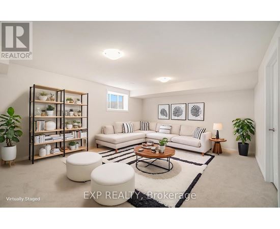 A living room with a white couch, a coffee table, and a bookshelf.