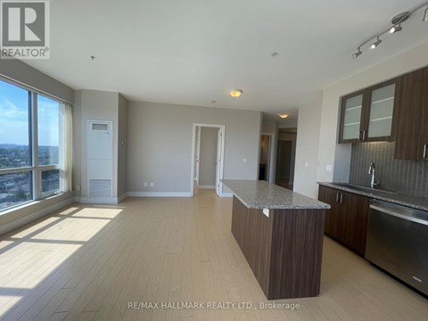 A spacious kitchen with wooden cabinets and a central island.