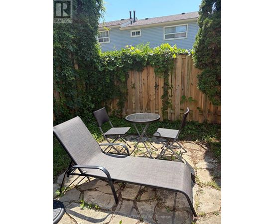 A backyard with a table and chairs.
