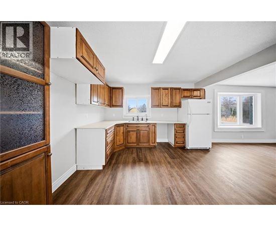 A kitchen with wooden cabinets and a white refrigerator.