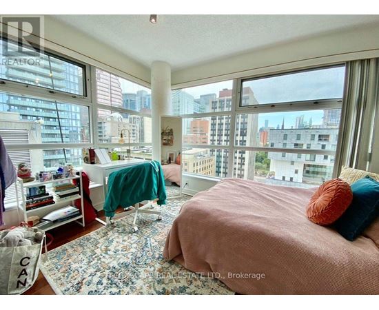 A bedroom with a large bed and a view of the city.