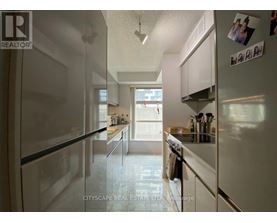 A kitchen with white appliances and cabinets.