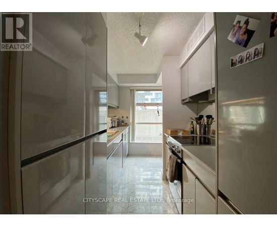 A kitchen with white appliances and cabinets.