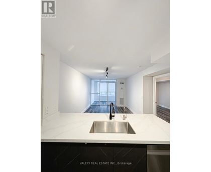 A modern kitchen with a sink and a window.