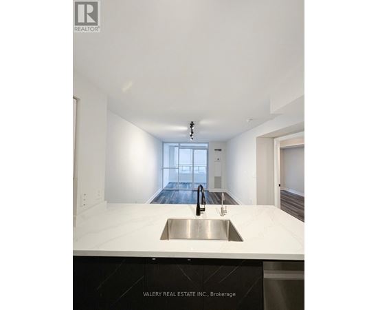 A modern kitchen with a sink and a window.