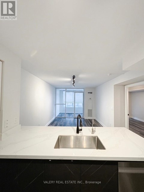 A modern kitchen with a sink and a window.