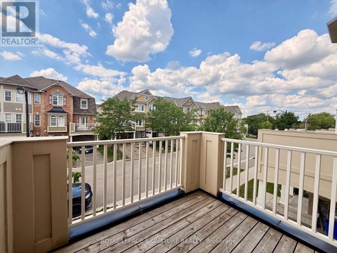 A balcony with a railing and a view of a residential area.