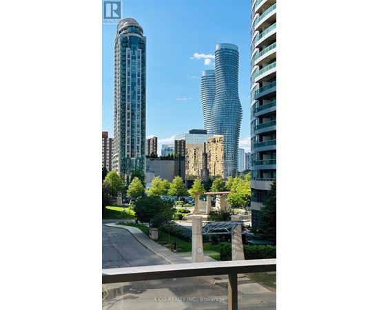 A cityscape with modern buildings and a clear sky.