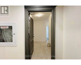 A hallway with a brokerage sign on the wall.