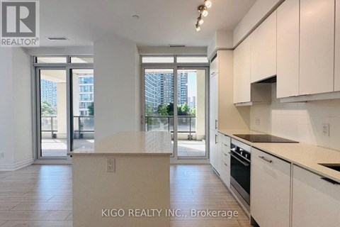 A kitchen with white cabinets and a countertop with a sign that says KIGO REALTY INC., Brokerage.