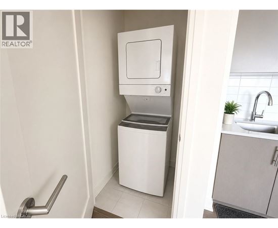 A white toilet with a bidet attachment is installed in a bathroom.